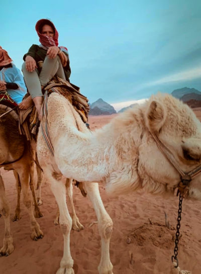 student from Shababeek center for spoken Arabic study on a camel in Wadi Rum